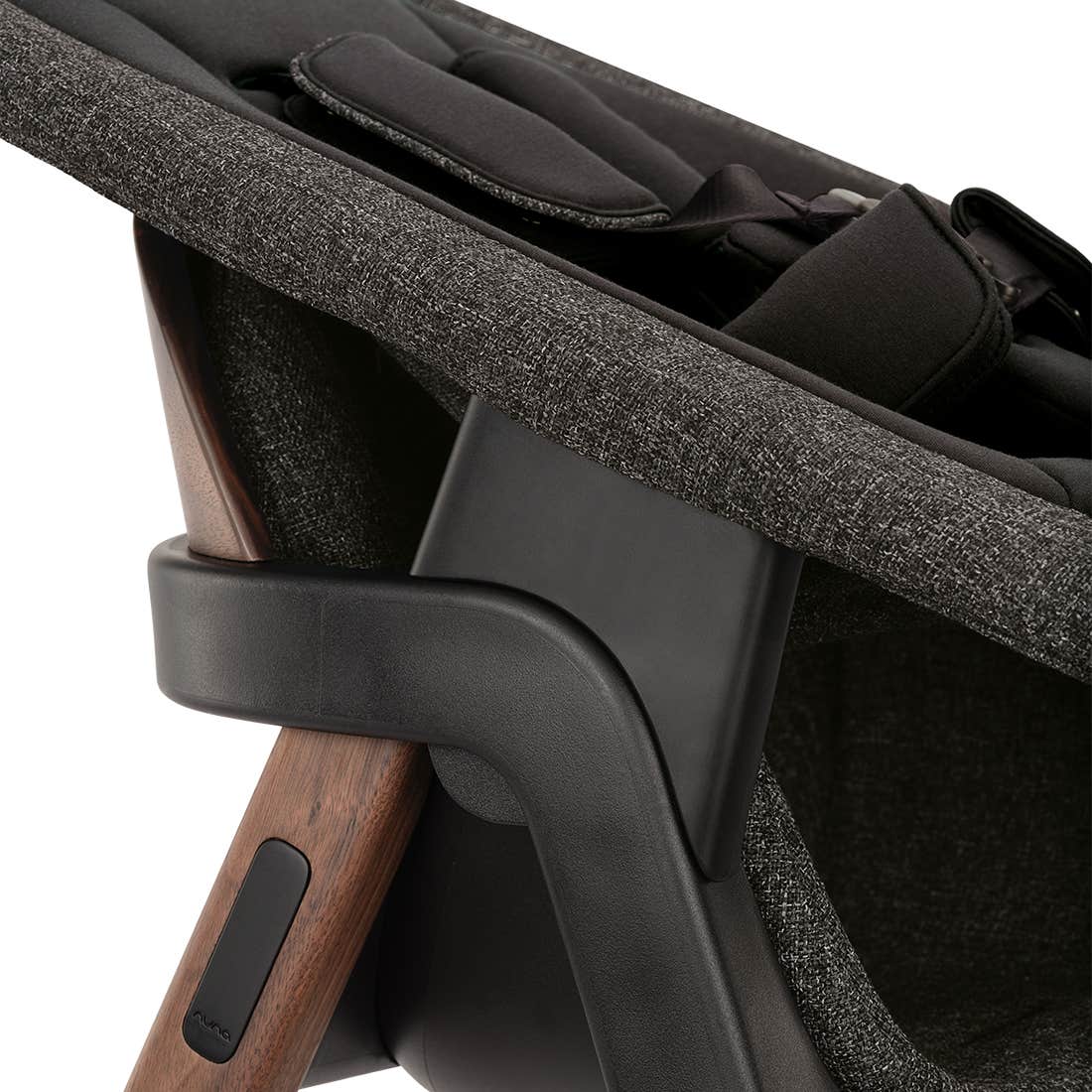Close-up of a stroller seat with wooden handle and black fabric
