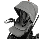 Snack tray attached to a grey stroller showing it in an outward position