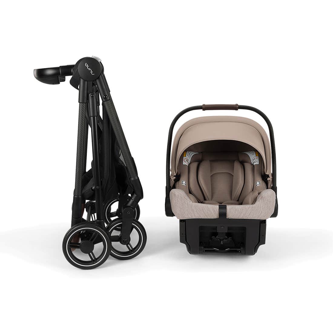A Cybex stroller and infant car seat travel system shown on a clean white background. The stroller is folded on the left in black, and the infant car seat with a beige/tan hood and harness base is shown on the right.