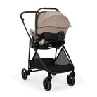 A stroller with a black frame and a beige baby seat insert, shown on a clean white background.