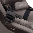 Close-up of a Nuna car seat with a focus on the buckle and logo.