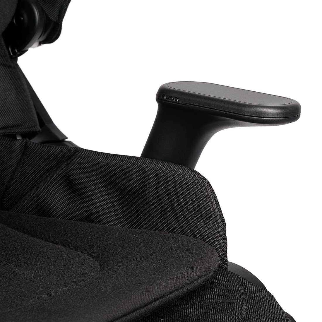 Close-up of a black ergonomic office chair showing the textured fabric seat, armrest, and part of the headrest against a white background.