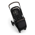 Black stroller with brown accents on a white background