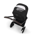 Black stroller with a white canopy on a white background