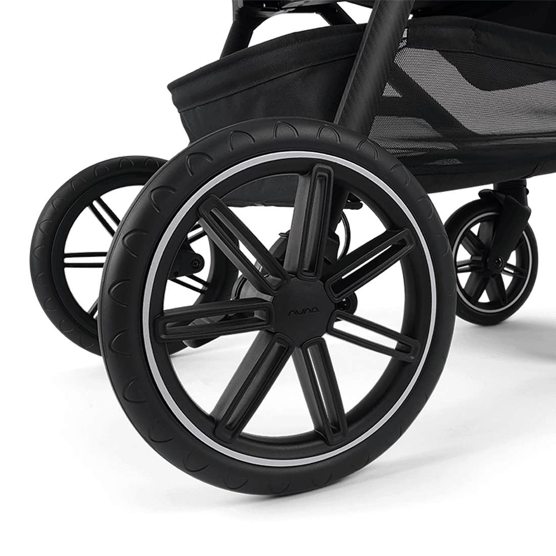 Close-up of a black stroller wheel on a white background