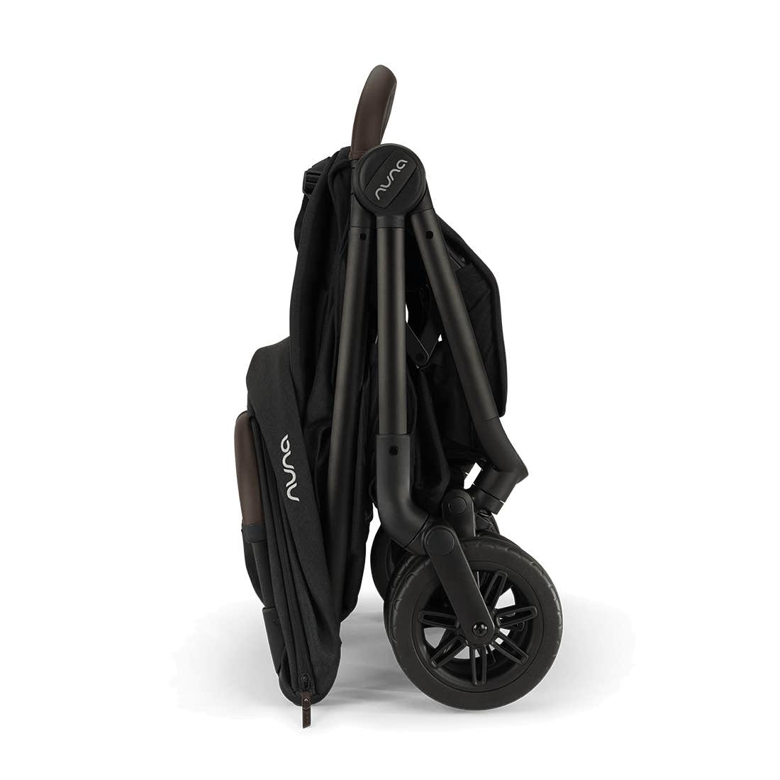 Nuna TRVL 360 lightweight travel stroller in Caviar black, shown in a folded, freestanding position against a clean white background with a brown leatherette pushbar visible at the top.