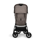 Nuna TRVL 360 lightweight travel stroller in Cedar brown, shown from the rear with the canopy extended to reveal a mesh ventilation window and a brown leatherette pushbar against a clean white background.
