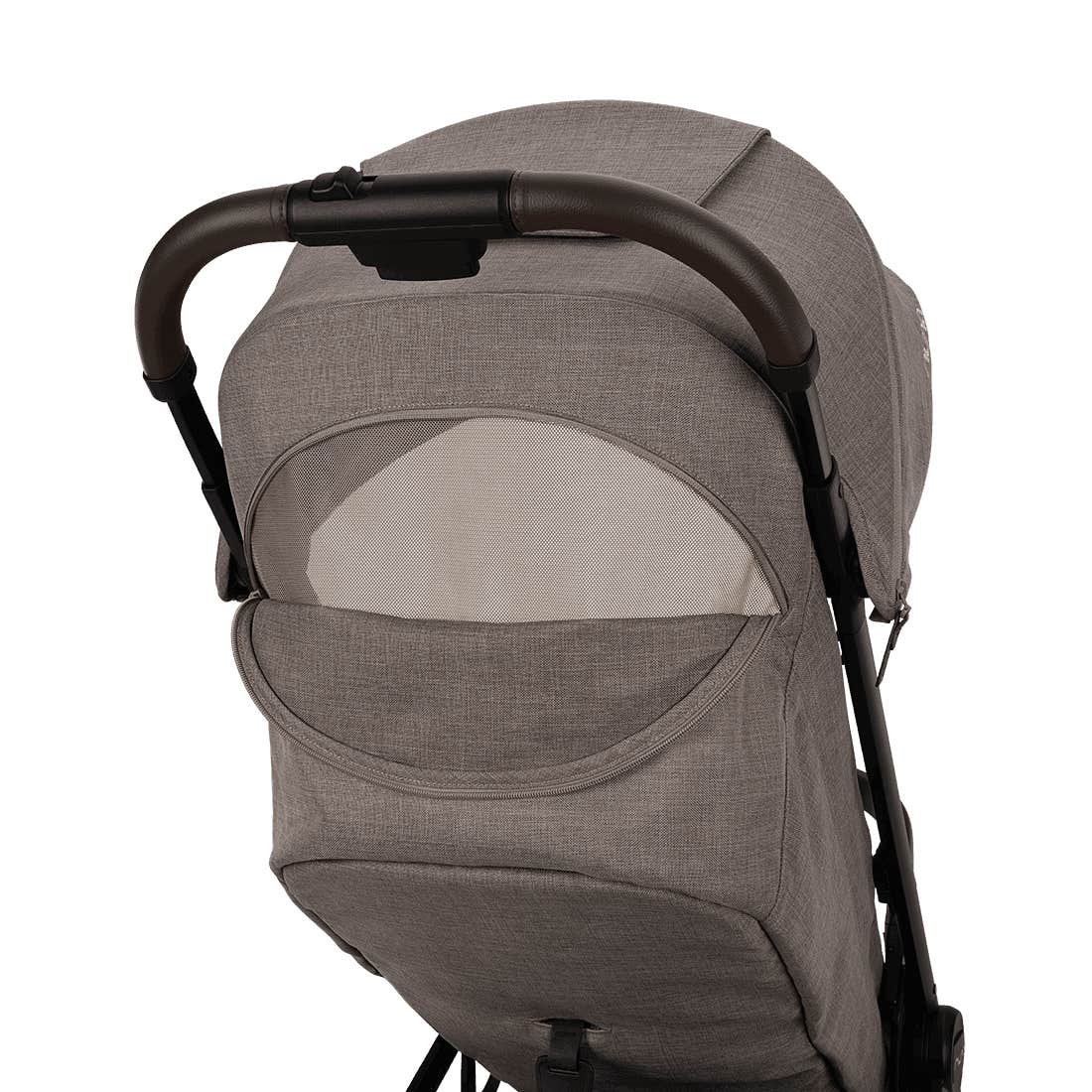 Nuna TRVL 360 lightweight travel stroller in Cedar brown, shown from the rear with the canopy extended to reveal a mesh ventilation window and a brown leatherette pushbar against a clean white background.
