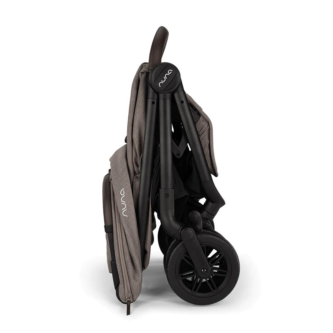 Nuna TRVL 360 lightweight travel stroller in Cedar brown, shown in a folded, freestanding position against a clean white background with a brown leatherette pushbar visible at the top.