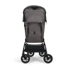Nuna TRVL 360 lightweight travel stroller in Pewter grey, shown from the rear with the canopy extended to reveal a mesh ventilation window and a brown leatherette pushbar against a clean white background.