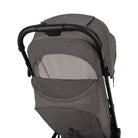 Nuna TRVL 360 lightweight travel stroller in Pewter grey, shown from the rear with the canopy extended to reveal a mesh ventilation window and a brown leatherette pushbar against a clean white background.