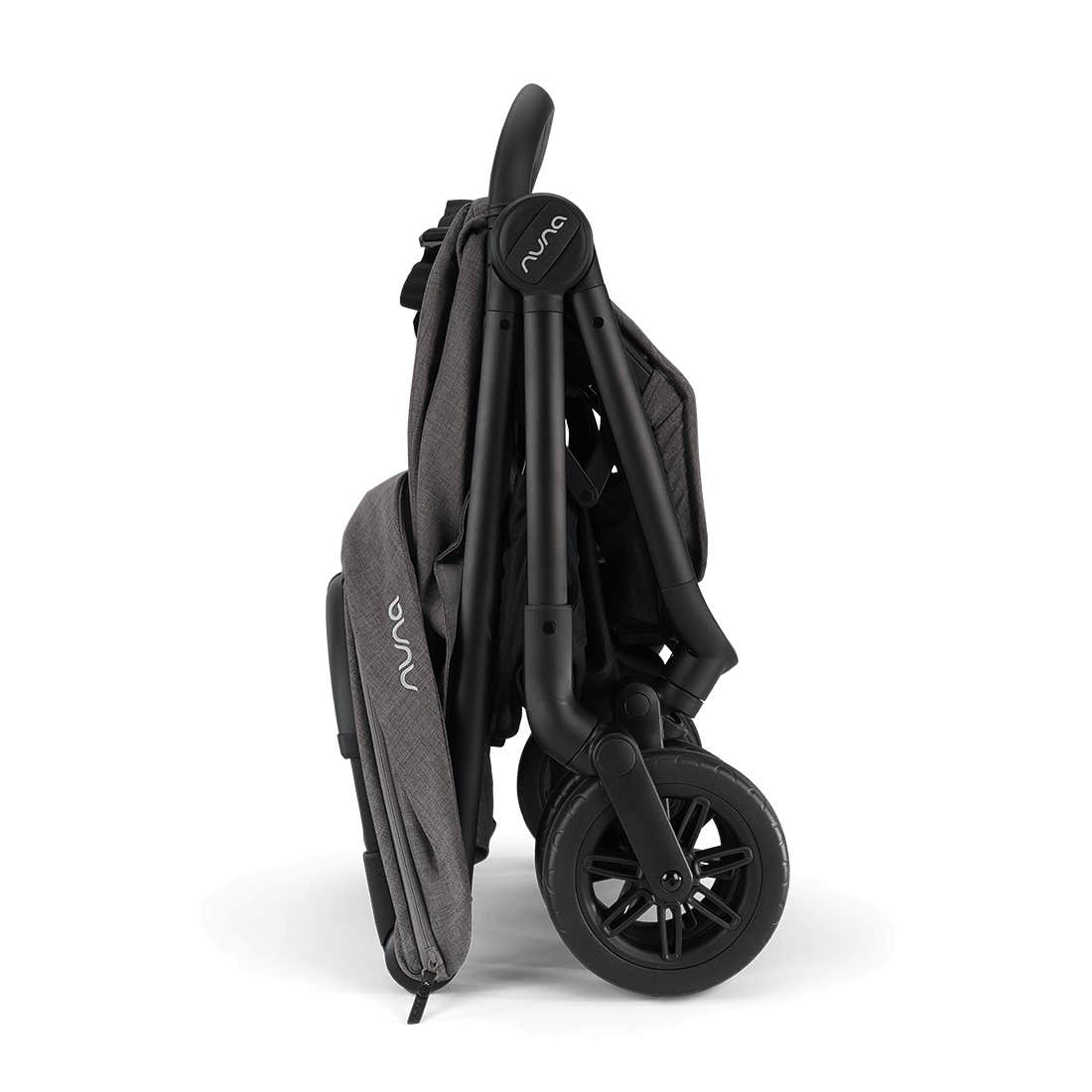 Nuna TRVL 360 lightweight travel stroller in Pewter grey, shown in a folded, freestanding position against a clean white background with a brown leatherette pushbar visible at the top.