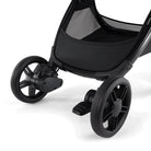Close-up of a black stroller wheel on a white background