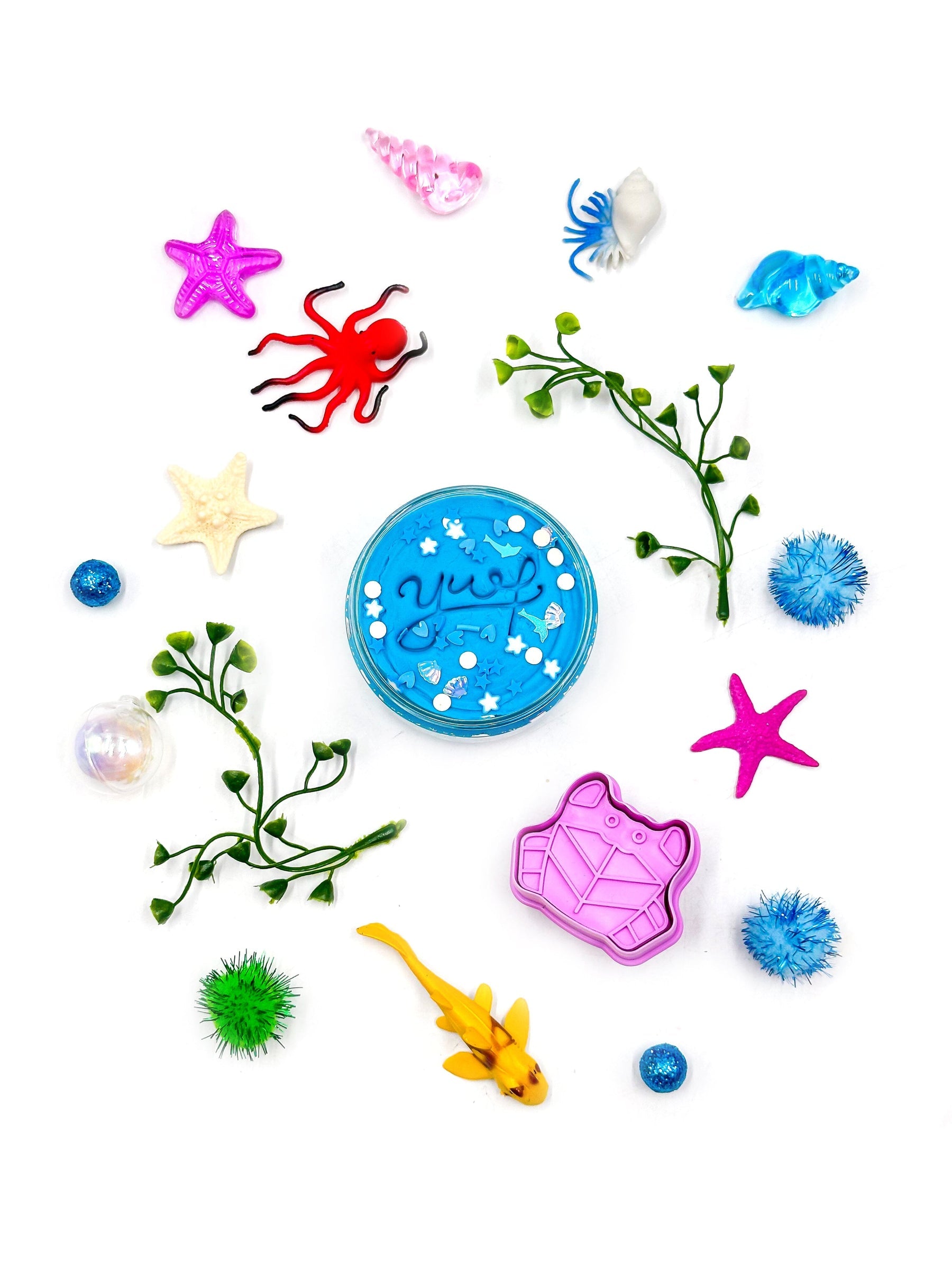 Colorful sea-themed toys and accessories on a white background