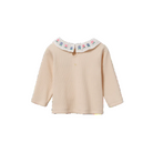 A beige ribbed long-sleeve baby top with a white Peter Pan collar decorated with colorful embroidered letters, shown on a plain white background.