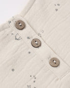 Close-up of a textured fabric with button details and star patterns.