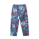 A pair of children's pants featuring a dense, colorful floral print on a dark blue background, including white, pink, red, and yellow flowers, shown against a plain white background.