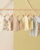 Children's clothing on hangers against a colorful background