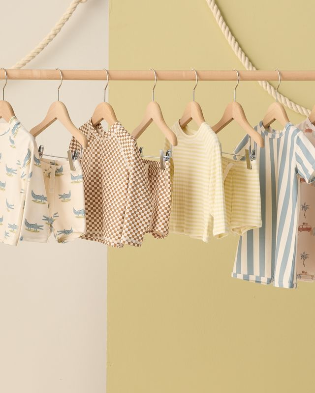 Children's clothing on hangers against a colorful background
