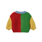 A colorful knit sweater with a red and green textured front, yellow sleeves, and a light blue ribbed collar, shown against a plain white background.