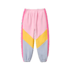 A pair of children's fleece jogger pants featuring a retro colorblock design with pink, yellow, and light blue panels, shown against a plain white background.