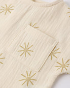 Beige fabric with gold star patterns on a white background