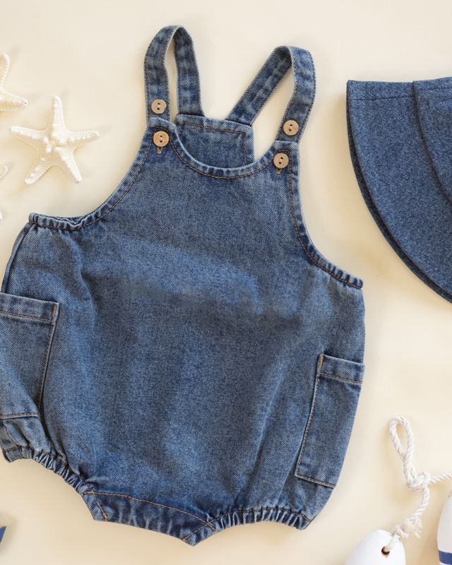 Denim romper with button details on a light background