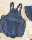 Denim romper with button details on a light background