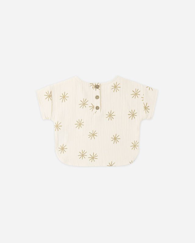 Baby romper with gold star pattern on a white background