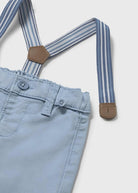 Light blue pants with striped suspenders on a white background