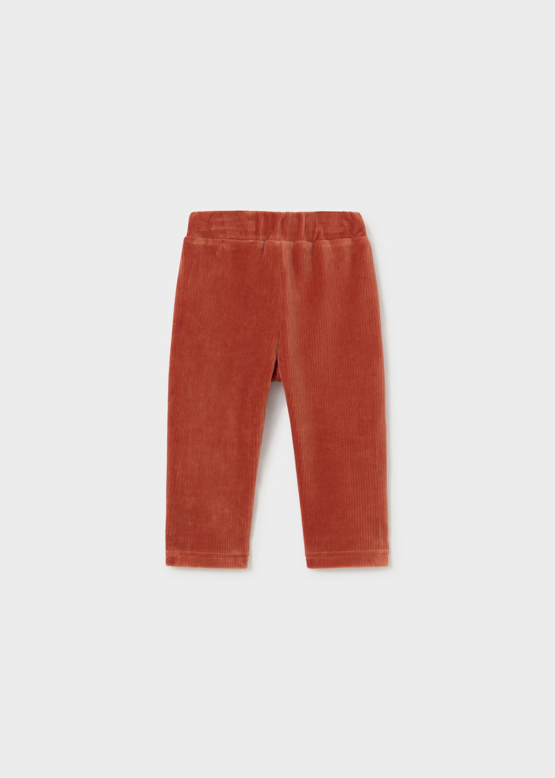 A pair of Mayoral baby corduroy jogger trousers in a terracotta/teja orange color with a soft textured finish.