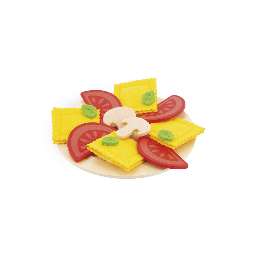 Toy food set with yellow squares, red tomatoes, and green leaves on a white background