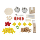 Set of toy kitchen items including pasta, cut vegetables, and cooking utensils on a white background