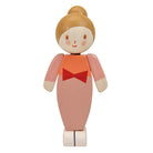 A wooden toy doll with a round painted head, peach-colored body, orange top, and red bow detail, shown on a plain white background.