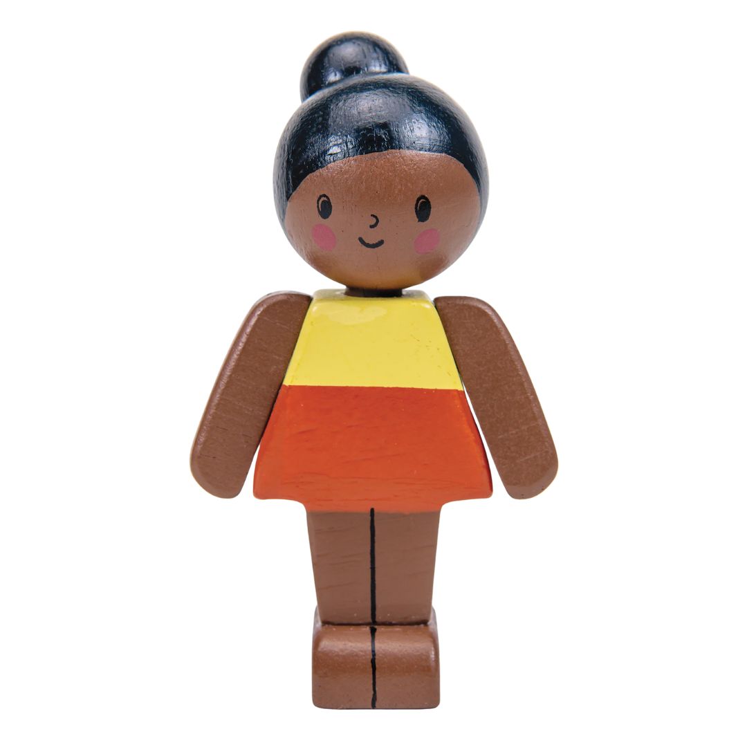 Wooden toy figure of a girl with a yellow and orange dress on a white background