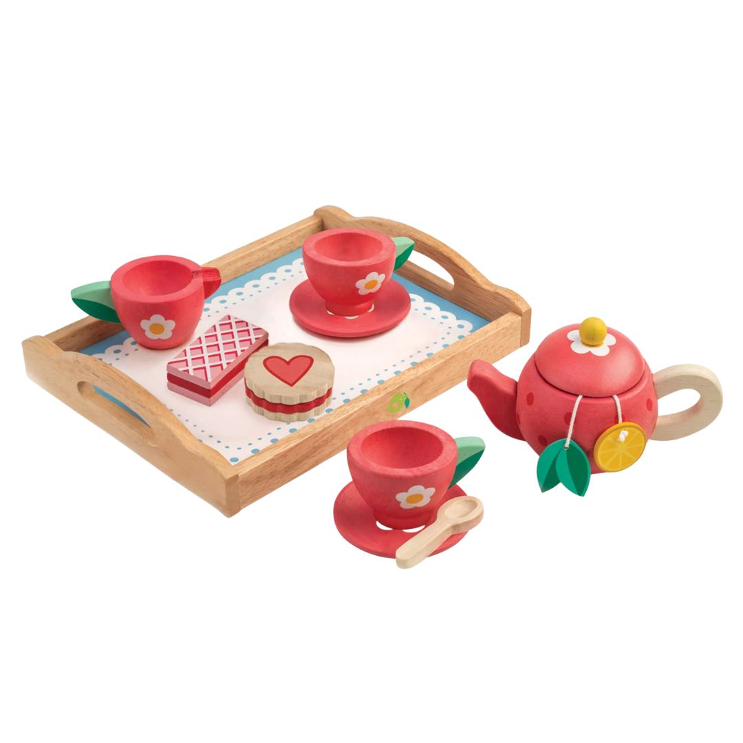 Children's wooden tea set with red teacups, cookies, and a teapot on a white background