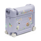 A lavender children's rolling storage trunk decorated with colorful travel-themed stickers and the word 'TRAVEL' on the lid, shown on a clean white background.