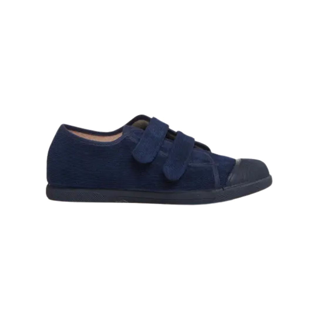 A navy blue low-top canvas shoe with two hook-and-loop strap closures and a rubber toe cap, shown in profile against a plain white background.