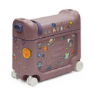 A child's travel suitcase in a dusty mauve color, decorated with space-themed stickers including planets, astronauts, and the word 'TRAVEL' on the lid, shown on a clean white background.