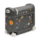A dark gray children's play suitcase with white wheels, featuring a space-themed design with stickers of planets, a sun, rockets, and the word 'TRAVEL' on top.