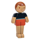 Wooden toy figure of a person with a black shirt and red shorts on a white background