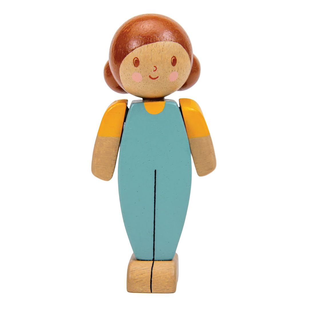 Wooden toy figure of a girl with a blue dress and yellow top on a white background