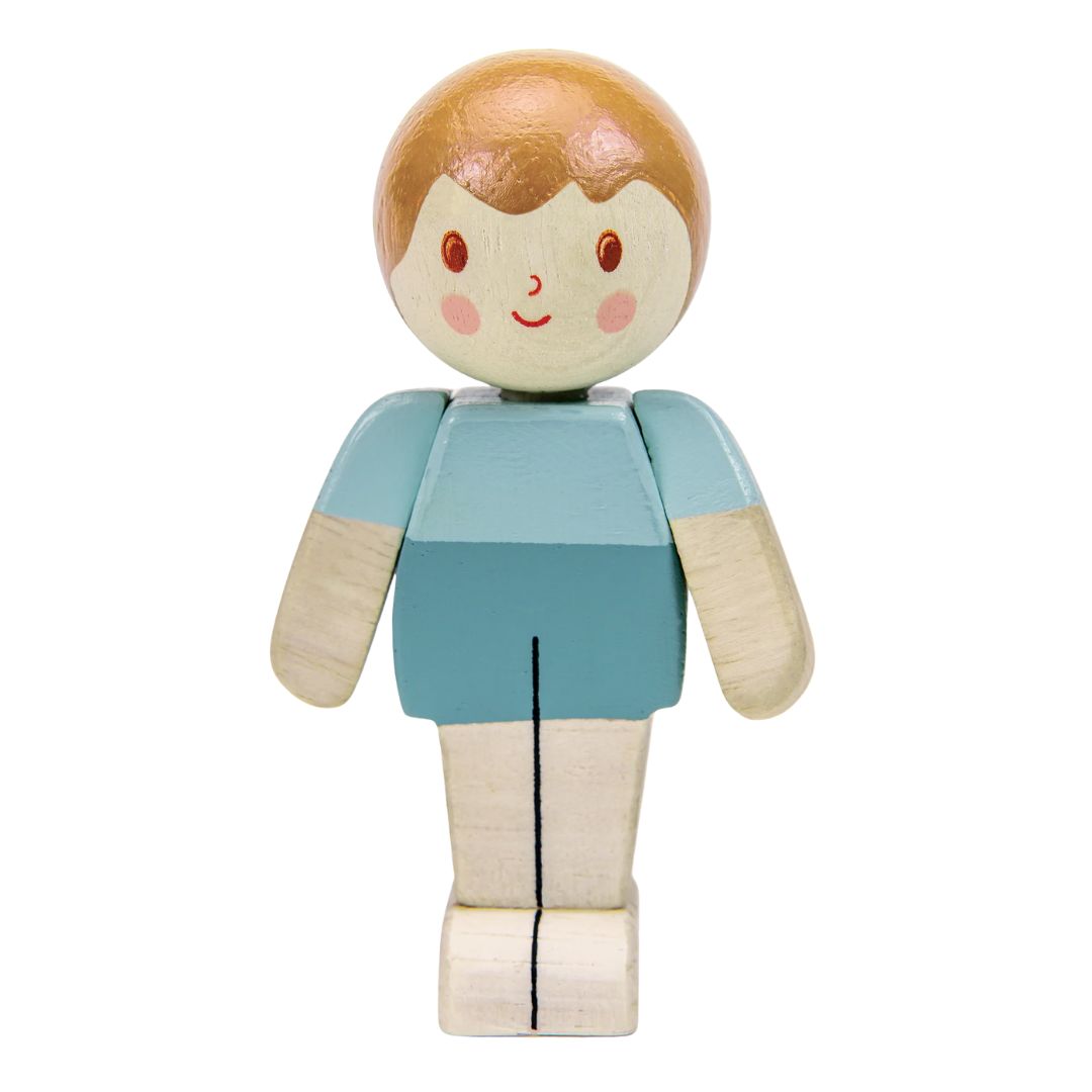 A hand-painted wooden toy figure with a round head, light brown hair, a cream face, pink cheeks, and a light blue shirt with cream-colored arms and legs, shown against a plain white background.