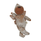 A plush baby angel doll with brown skin, closed eyes, and wings, wearing a beige velvet hooded onesie with a small rainbow detail, isolated on a white background.