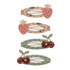 Set of three decorative hair clips with strawberry and cherry designs on a white background