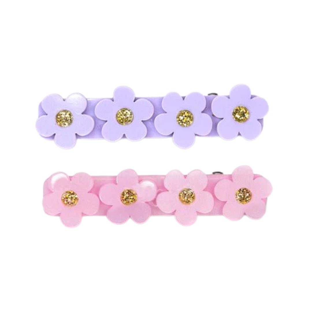 Two sets of flower-shaped hair clips in purple and pink with gold centers on a white background.