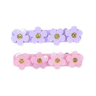 Two sets of flower-shaped hair clips in purple and pink with gold centers on a white background.