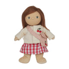 A doll with long brown hair, wearing a cream cardigan, a red and white gingham skirt, and a pink cherry-patterned crossbody bag, shown against a plain white background.