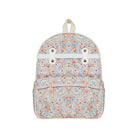 A small backpack with a pastel floral and butterfly pattern on a light pink background, featuring a white horizontal strap across the top front with two gold-tone grommets and a cream-colored top handle, shown against a plain white background.