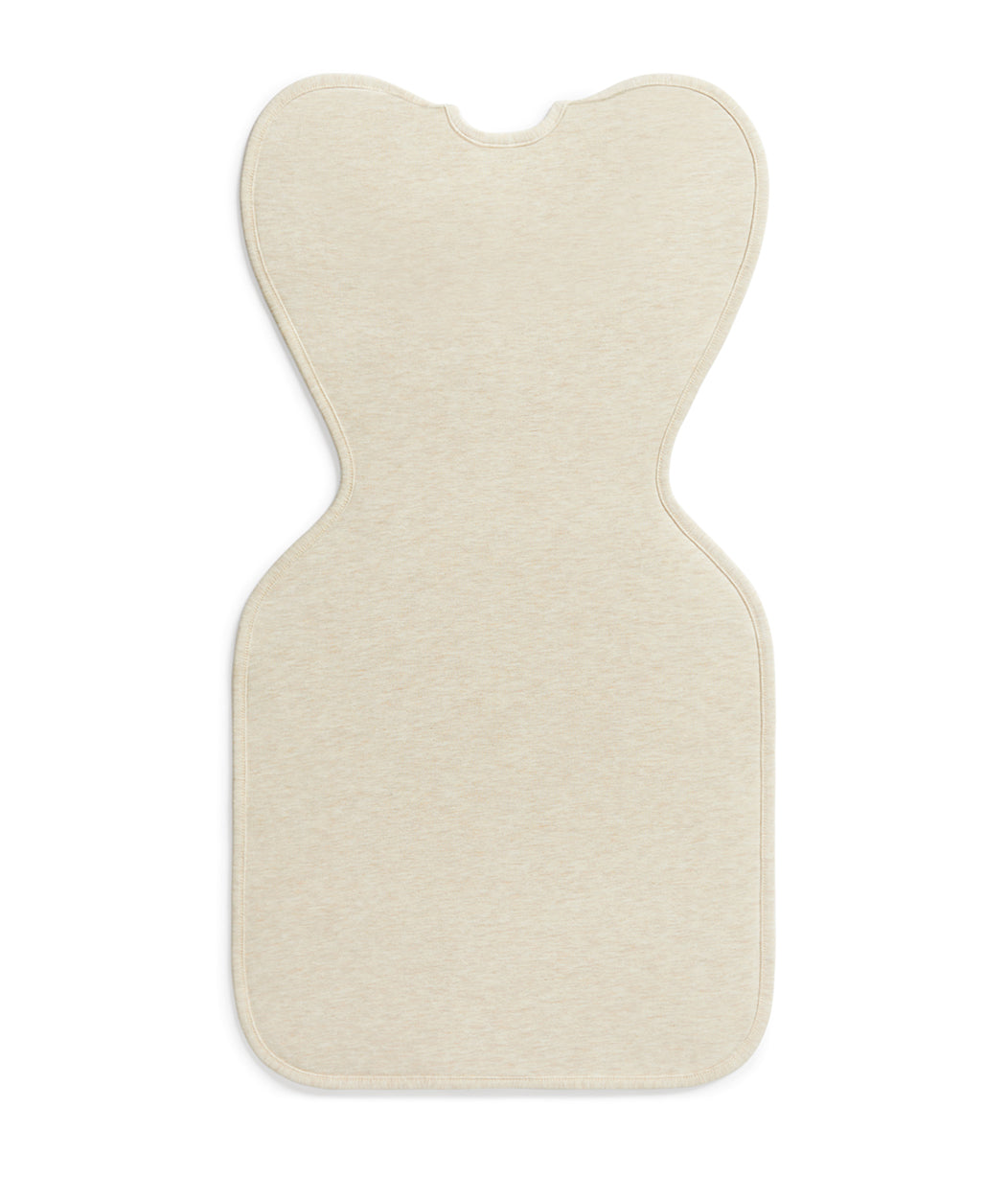 Beige bath mat with a unique cut-out design on a white background